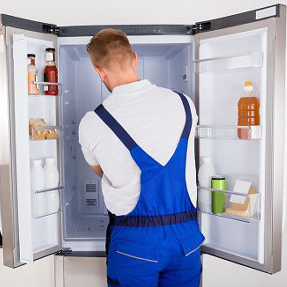 Technician repairing refrigerator